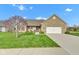 Charming brick home featuring a well-manicured lawn, flowering tree, and attached two-car garage at 2601 Viceroy Ln, Lebanon, IN 46052