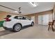 Well-organized garage featuring clean epoxy floors, an SUV and a view of the side door at 2601 Viceroy Ln, Lebanon, IN 46052