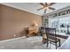 Home office with a desk, ceiling fan, plush carpeting, and shelving for storage and display at 2601 Viceroy Ln, Lebanon, IN 46052