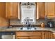 Bright kitchen featuring granite countertops, stainless steel sink, wooden cabinets, and modern fixtures at 2601 Viceroy Ln, Lebanon, IN 46052