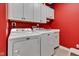 Functional laundry room with side by side washer and dryer, ample storage cabinets, and convenient sink at 2601 Viceroy Ln, Lebanon, IN 46052