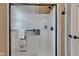 Clean white tiled shower featuring sleek glass doors, black hardware, and a towel rack at 2601 Viceroy Ln, Lebanon, IN 46052
