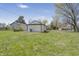 Backyard featuring a lush green lawn and mature trees at 2631 Collier St, Indianapolis, IN 46241