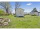 A backyard with a white shed provides practical storage space and complements the outdoor area at 2631 Collier St, Indianapolis, IN 46241