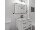 Modern bathroom features a stylish vanity with granite countertop and a sleek, black faucet, complemented by subway tile walls at 2631 Collier St, Indianapolis, IN 46241