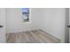 Bright, airy bedroom featuring stylish, light wood-look floors and a window with an outside view at 2631 Collier St, Indianapolis, IN 46241