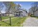 Charming home with a fenced yard and a gravel driveway on a sunny day at 2631 Collier St, Indianapolis, IN 46241