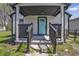 Inviting front porch featuring a vibrant blue door and classic black railings at 2631 Collier St, Indianapolis, IN 46241