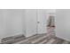 Hallway with wood-look flooring leading to a kitchen with stainless appliances at 2631 Collier St, Indianapolis, IN 46241