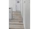 Hallway featuring modern vinyl floors, white walls, and a front door with glass panes at 2631 Collier St, Indianapolis, IN 46241