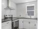 Modern kitchen featuring stainless steel appliances, white cabinets, and dark countertops at 2631 Collier St, Indianapolis, IN 46241