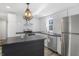 Well-lit kitchen with stainless appliances, stylish light fixture, and subway tile backsplash at 2631 Collier St, Indianapolis, IN 46241