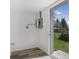 Utility room features modern floors, white walls, a gray electrical panel, and a door leading to the backyard at 2631 Collier St, Indianapolis, IN 46241