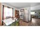 A bright dining area is shown, featuring a modern table with seating for four, a hutch and stainless steel refrigerator at 3021 Midvale Dr, Indianapolis, IN 46222