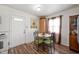 Bright dining room with a table set, a door to the outside, and a large storage cabinet at 3021 Midvale Dr, Indianapolis, IN 46222