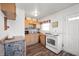 This kitchen features wood cabinets, modern appliances and a tile backsplash above the sink at 3021 Midvale Dr, Indianapolis, IN 46222