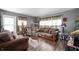 Cozy living room with hardwood floors, two sofas, an arm chair and decorative curtains at 3021 Midvale Dr, Indianapolis, IN 46222