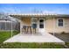 Inviting patio featuring a retractable awning, table, and chairs for outdoor enjoyment at 3021 Midvale Dr, Indianapolis, IN 46222