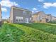 Well-maintained backyard featuring lush green grass, a black chain fence and a patio area with seating at 3053 Creekridge Ct, Columbus, IN 47201