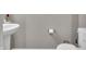 Bathroom featuring a toilet and pedestal sink with modern fixtures and clean design at 3053 Creekridge Ct, Columbus, IN 47201