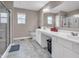 Bathroom featuring a spacious vanity with dual sinks and a glass-enclosed shower at 3053 Creekridge Ct, Columbus, IN 47201