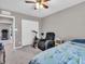 Bedroom featuring comfortable seating, a ceiling fan, and a double-door closet at 3053 Creekridge Ct, Columbus, IN 47201