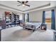 Spacious bedroom featuring tray ceilings, a ceiling fan, and large windows with natural light at 3053 Creekridge Ct, Columbus, IN 47201