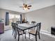 Bright dining room with a modern ceiling fan, carpet flooring and a view of the front yard through the window at 3053 Creekridge Ct, Columbus, IN 47201