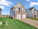 Two-story home with a two-car garage, siding, and front lawn at 3053 Creekridge Ct, Columbus, IN 47201