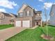 Charming two-story home with a well-maintained front lawn and two-car garage at 3053 Creekridge Ct, Columbus, IN 47201