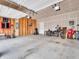 Spacious garage with ample storage space, tools, a motorcycle, and potential for a workshop or parking area at 3053 Creekridge Ct, Columbus, IN 47201