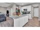 Kitchen island with bar stools, white cabinets, and granite countertops at 3053 Creekridge Ct, Columbus, IN 47201