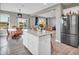 Open kitchen featuring island with granite countertop and seating, seamlessly flowing into the dining and living areas at 3053 Creekridge Ct, Columbus, IN 47201