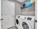 Laundry room featuring modern, front-loading washer and dryer units and ample cabinet space at 3053 Creekridge Ct, Columbus, IN 47201