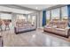 Living room with hardwood floors, modern light fixture, and bright, sunny windows at 3053 Creekridge Ct, Columbus, IN 47201