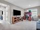 Comfortable living room featuring a TV, desk and chair, carpeting, neutral walls, and ample natural light at 3053 Creekridge Ct, Columbus, IN 47201