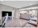 Open-concept living room with hardwood floors, a modern TV, and comfortable seating at 3053 Creekridge Ct, Columbus, IN 47201