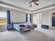 This spacious main bedroom features natural light, tray ceilings, and carpeted floors at 3053 Creekridge Ct, Columbus, IN 47201