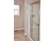Bathroom featuring a glass-enclosed shower and tile flooring near a window with natural light at 3078 Creekridge Ct, Columbus, IN 47201
