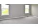 Bright, carpeted bedroom with two large windows offering ample natural light at 3078 Creekridge Ct, Columbus, IN 47201