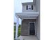 Close-up of the entryway featuring a sleek black door and brick facade at 3078 Creekridge Ct, Columbus, IN 47201