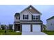 Two-story home with a brick and siding exterior, and a two-car garage, in a neighborhood at 3078 Creekridge Ct, Columbus, IN 47201