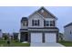 Charming two-story home featuring a brick-accented facade and a two-car garage at 3078 Creekridge Ct, Columbus, IN 47201