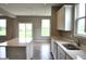 Open kitchen with a large central island, modern appliances, and plenty of natural light at 3078 Creekridge Ct, Columbus, IN 47201