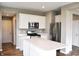 Modern kitchen featuring stainless steel appliances and a central island with quartz countertop at 3078 Creekridge Ct, Columbus, IN 47201