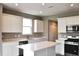 Well-lit kitchen with a central island, sleek countertops, and stainless steel appliances at 3078 Creekridge Ct, Columbus, IN 47201