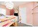 Charming pink bedroom featuring unique light fixture, floral wallpaper, and a bunk bed at 3414 Arbor Ave, Indianapolis, IN 46217