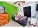Cozy bedroom featuring playful decor, a ceiling fan, and a large dresser for ample storage at 3414 Arbor Ave, Indianapolis, IN 46217