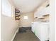 Well-lit laundry area with washer, dryer, and ample storage cabinets and shelving at 3414 Arbor Ave, Indianapolis, IN 46217