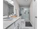 Modern bathroom with a glass shower, granite counters, and white cabinets at 3624 N Lakeside Dr, Muncie, IN 47304